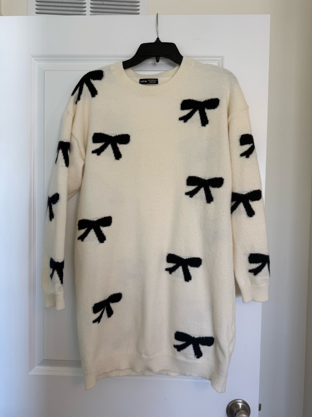 SHEIN Cream Crewneck Sweater Dress with Black Bow Pattern